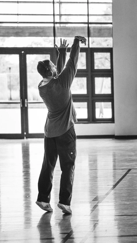 a little boy in the middle of throwing a basketball