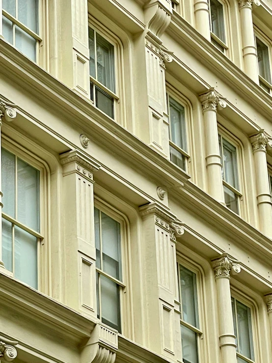 the white building has ornate windows and carved details