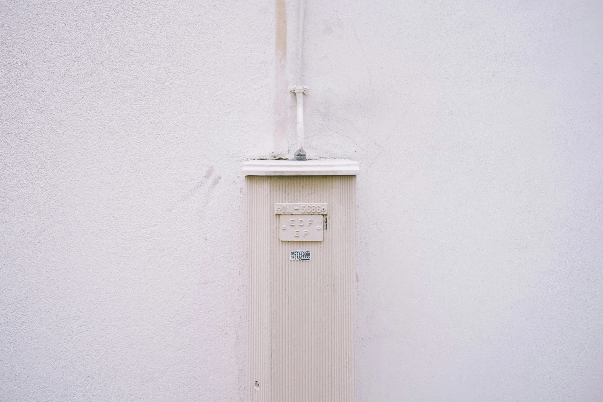 an old - fashioned gas furnace is in front of a white wall