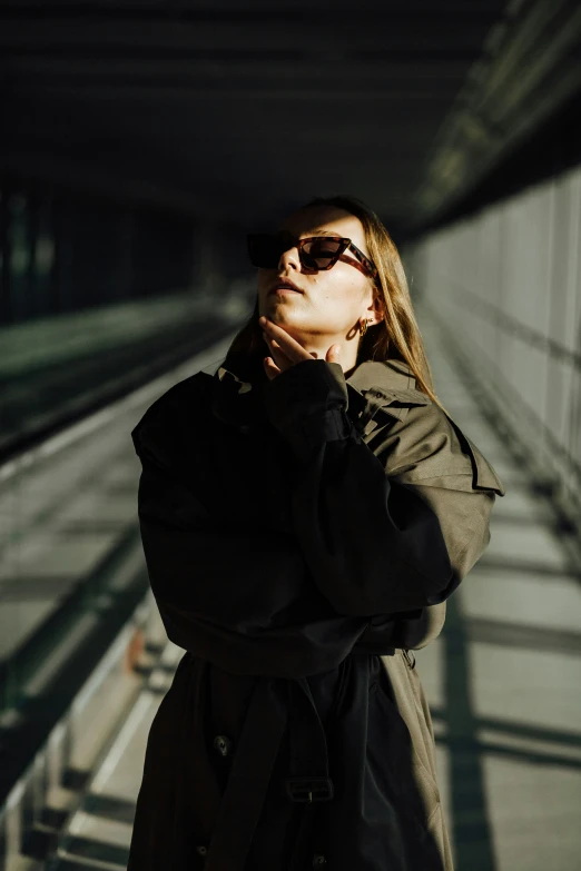 a woman with sunglasses looks up in the air