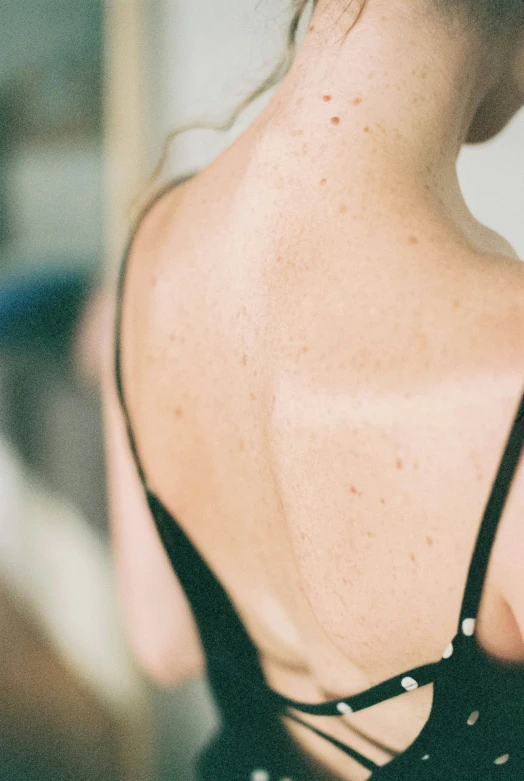 the back of a woman's bare - fronted body wearing black 