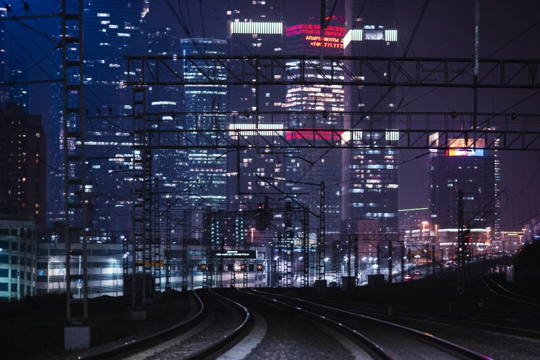 a train track with the lights on in the city