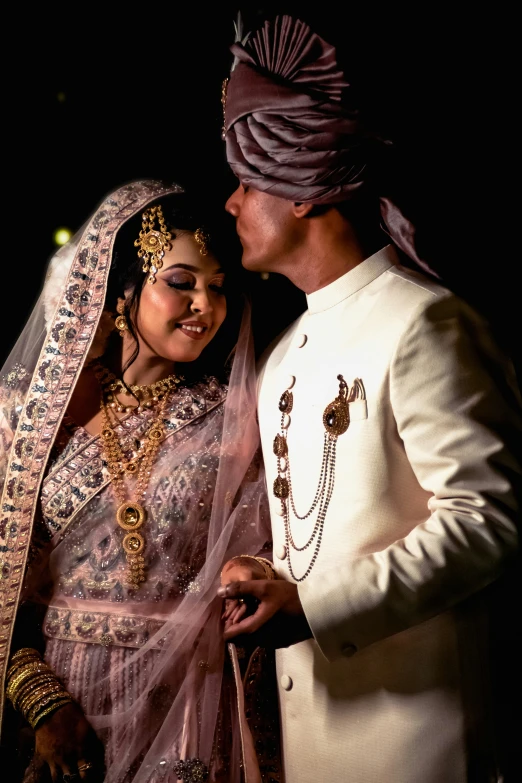 a bride and groom in turban on a night time date