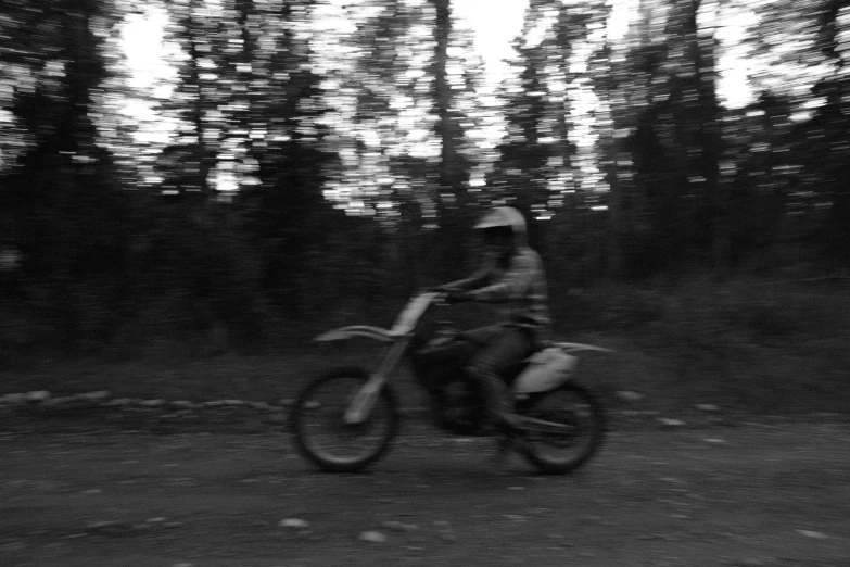 a person on a motorcycle driving down a road