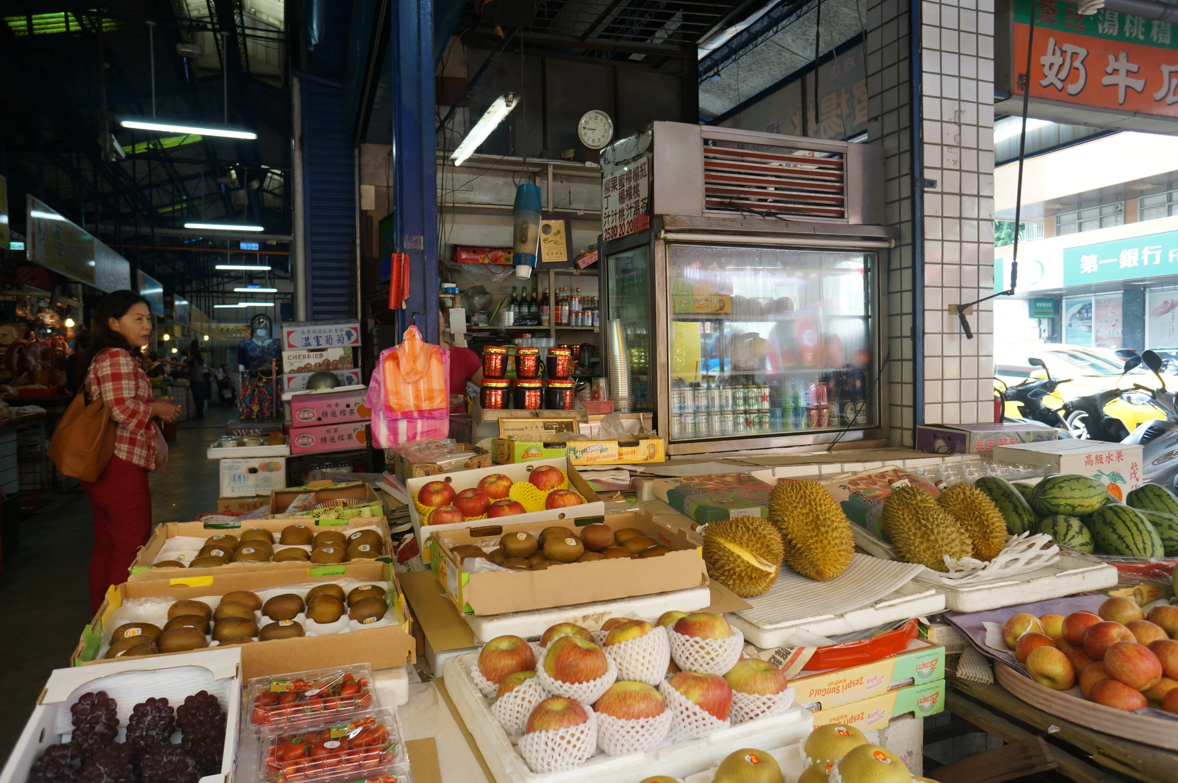 a variety of fruit are in trays at the grocery store