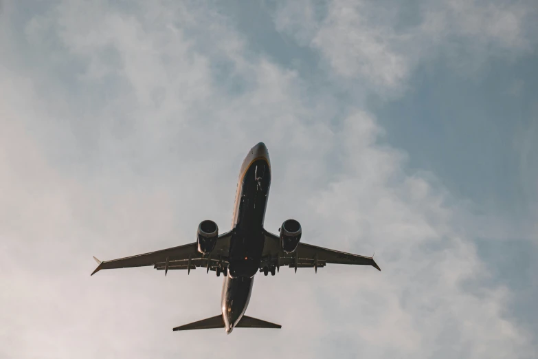 an airplane in the sky with its lights on