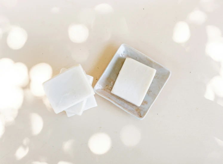 white plates on a table with a brown surface