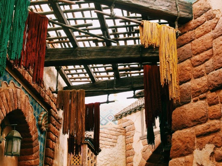 some colorfully hanging rope structures on a building