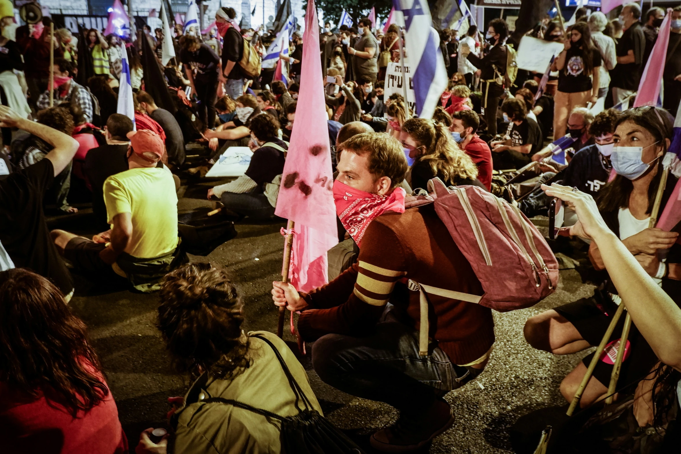 a large group of people sitting and standing around each other