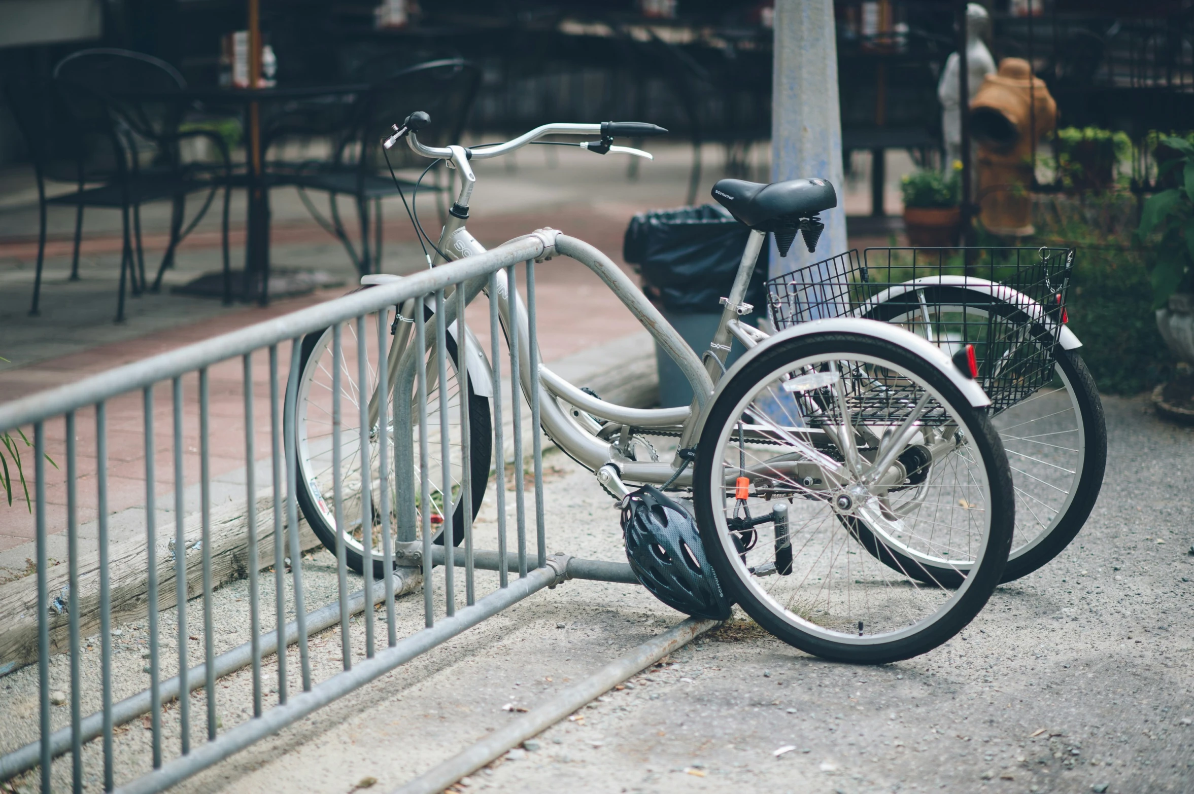 the two bicycle are locked to the side of the fence