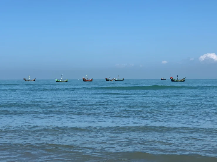small fishing boats are floating in the ocean