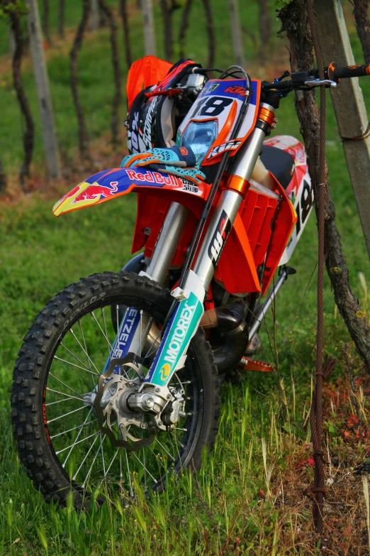 a dirt bike that is painted orange and blue