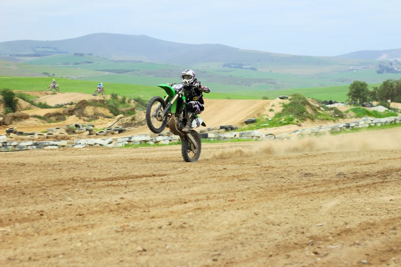 a person riding on a dirt bike on a dusty road