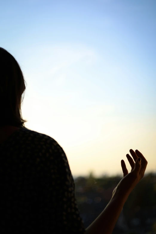 a woman is standing and clapping in a field