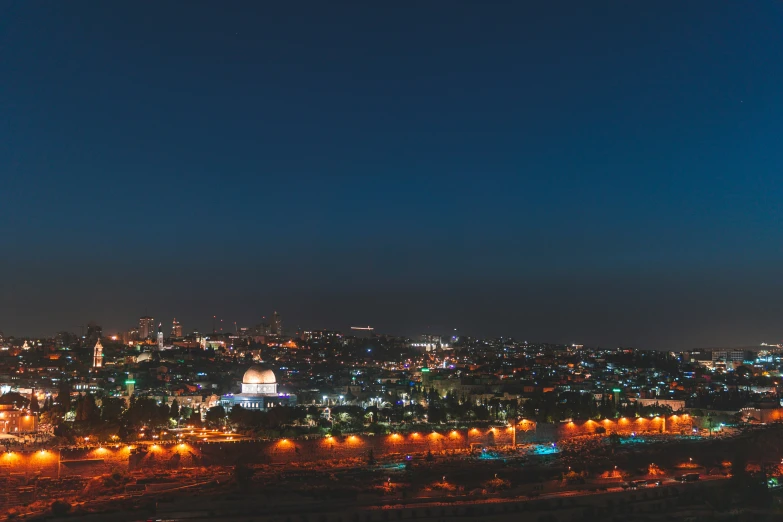 a city at night with illuminated lights, some with cars and buildings