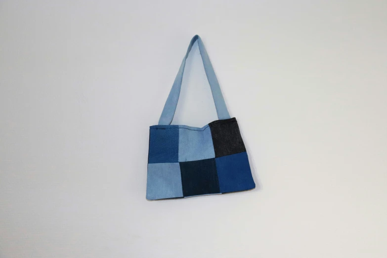 an oversize quilted tote bag on the wall