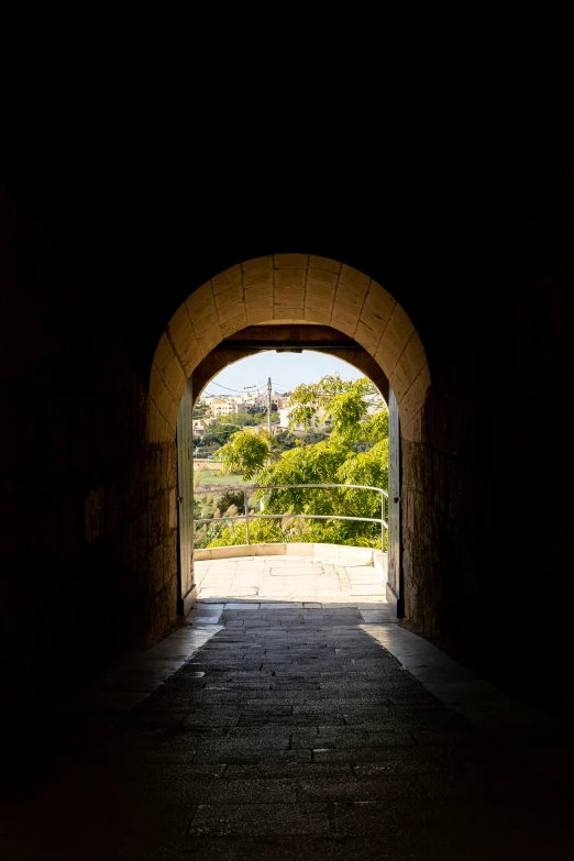 a dark tunnel leading into a small rural village