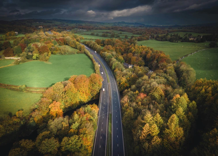 a highway runs parallel to a green field