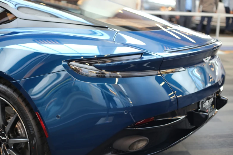 a blue sports car with the hood up