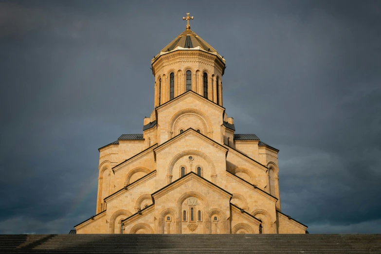 a tall steeple of a church under a cloudy sky