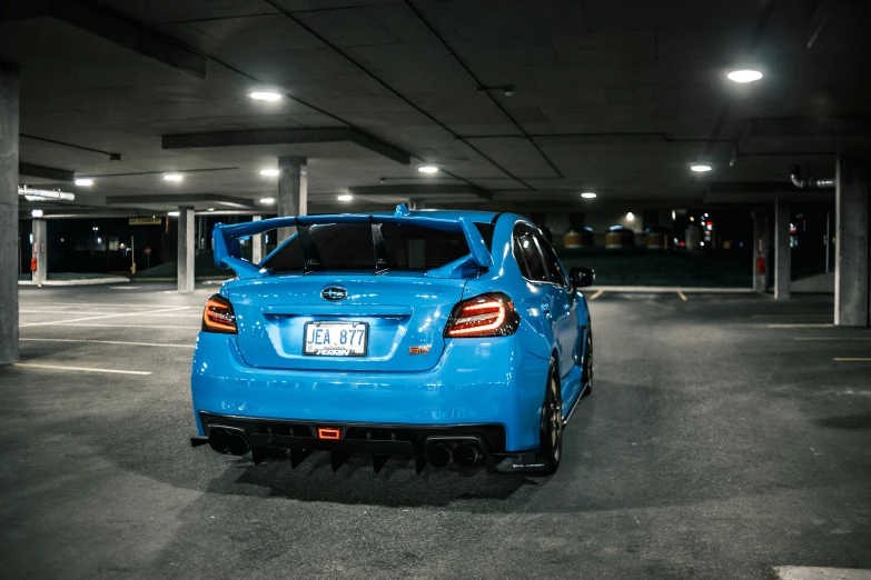 a blue car parked in a parking garage