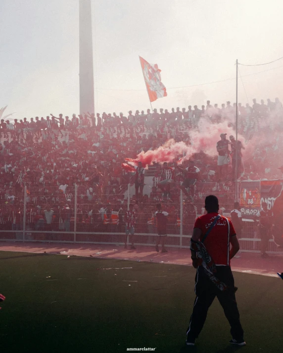 a group of people watching a game in front of a large crowd