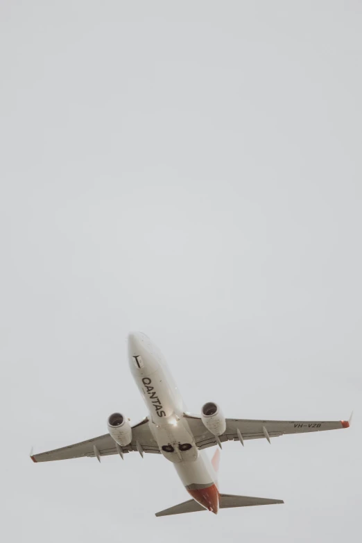 an airplane with it's landing gear down in the sky