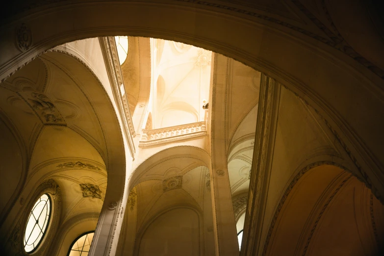 looking up through arches and the ceiling in an old church