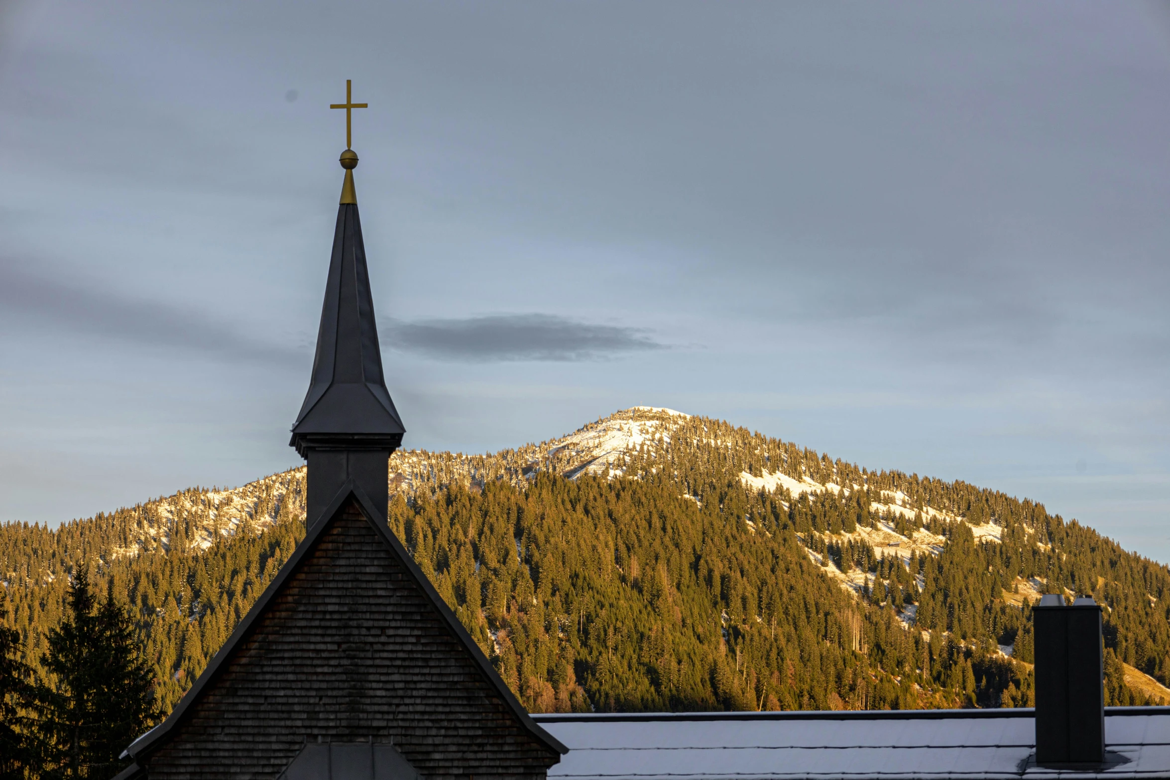 a church steeple with a cross on the top