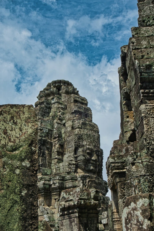 the ruins of an ancient city, including two stone statues