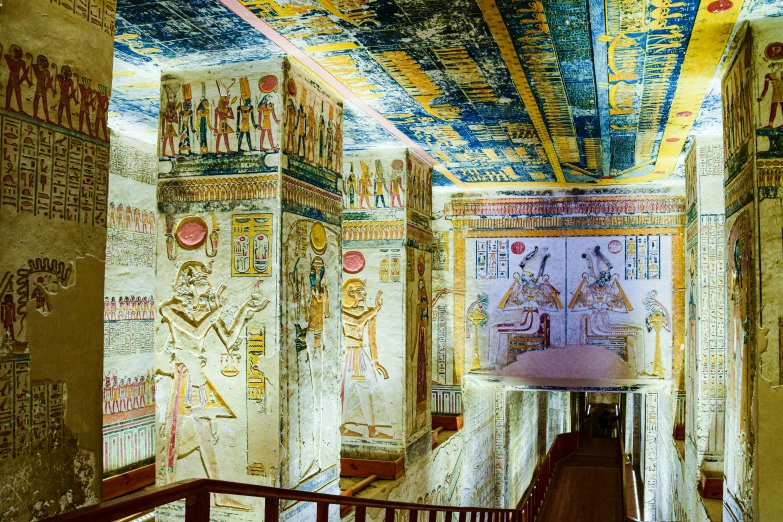 a hallway in the egyptian palace with many paintings on the wall