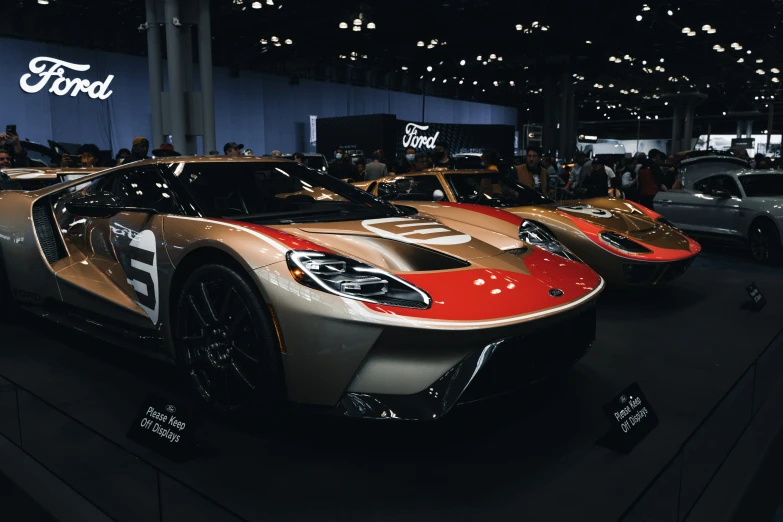 several different colored sport cars are parked on the show floor