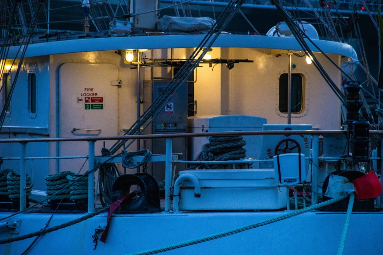 a large boat docked in the night with ropes