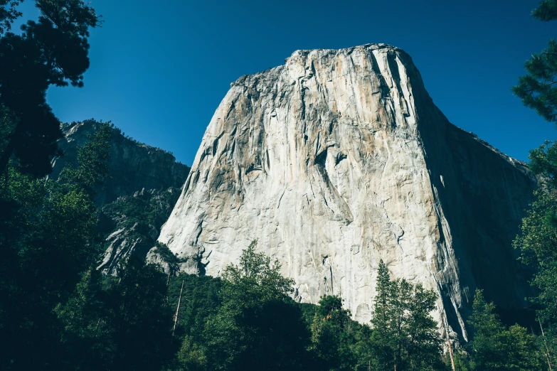 a mountain is against a clear sky filled with clouds