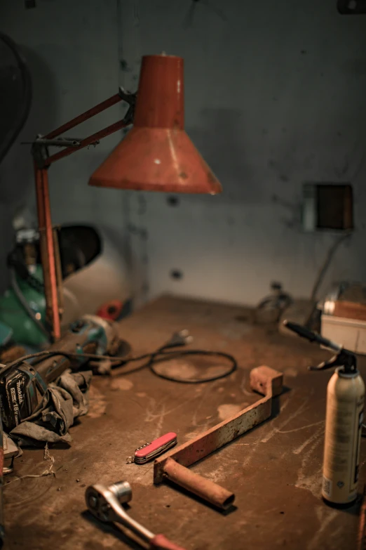 a desk with work tools on it in a dark room