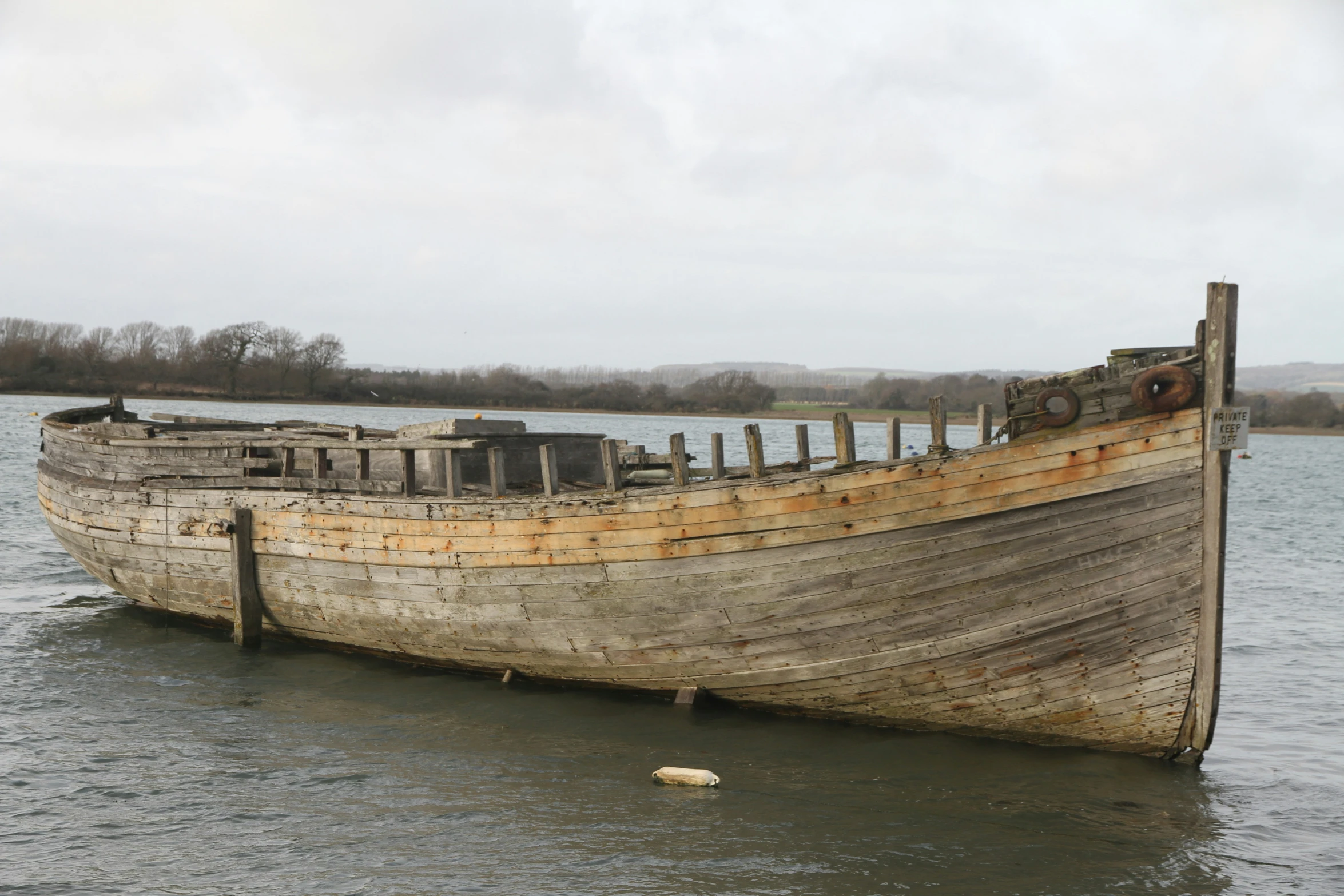 an old and dirty boat that is out in the water