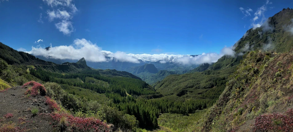 many clouds are rolling in over the mountains