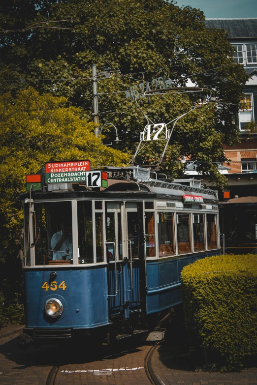 the trolley car is going through a residential area