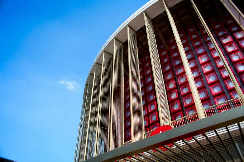 looking up at the curved red metal building