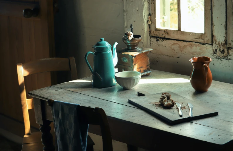 a table with many items on it sitting next to a window