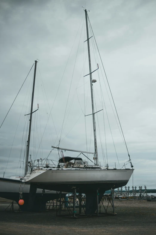 the sailboat sits on its side near the ocean