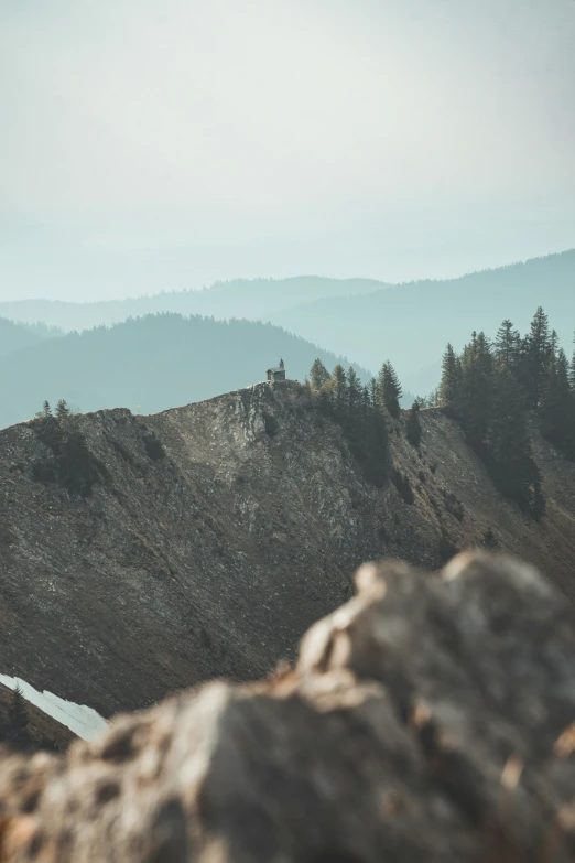 a mountain with a view of the mountains and trees