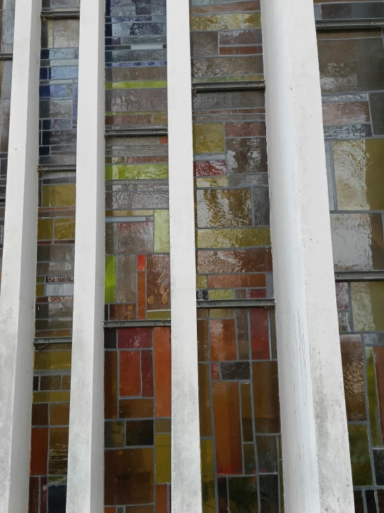 the columns of a building made out of various colored stained glass