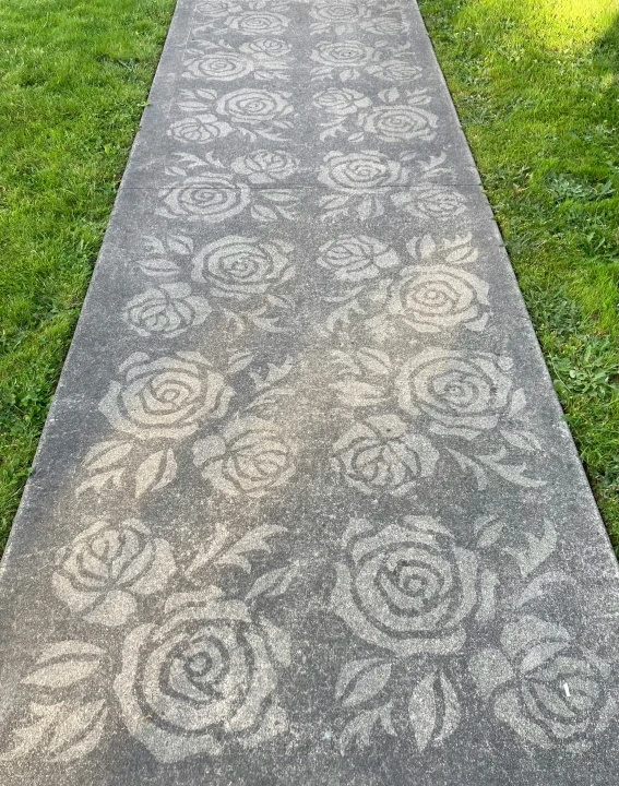 a walk way with a garden design on it