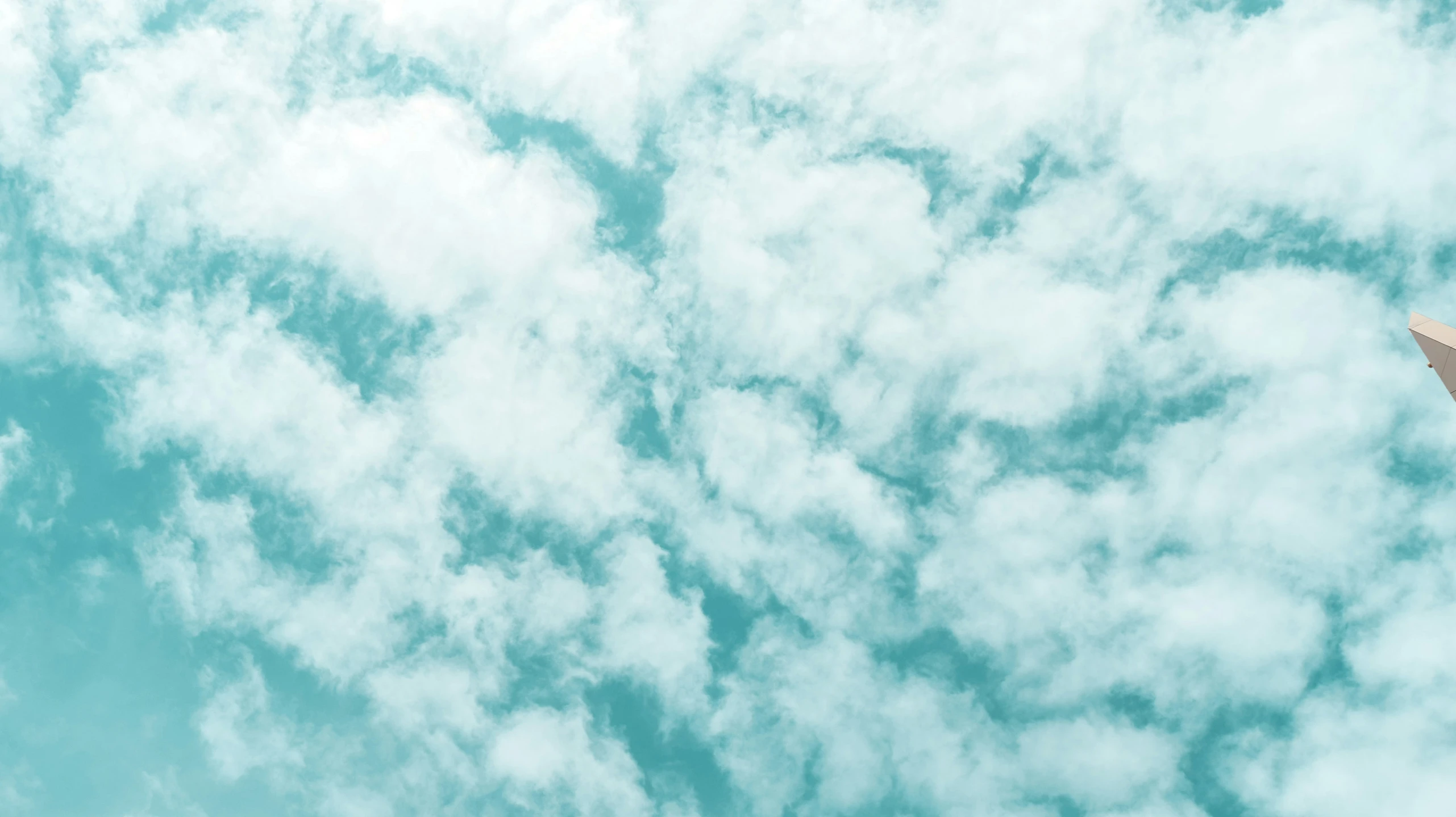 a large jetliner flying through a cloudy blue sky