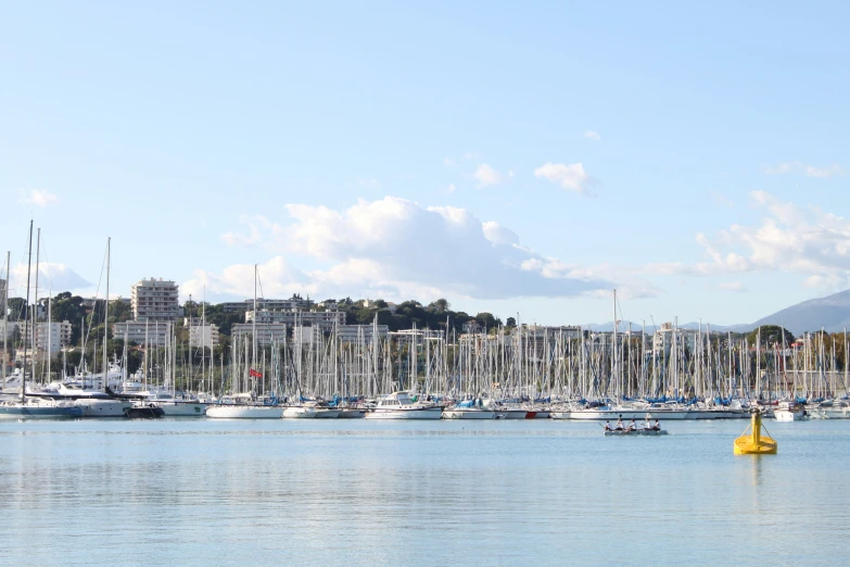 a harbor filled with lots of boats under a blue sky