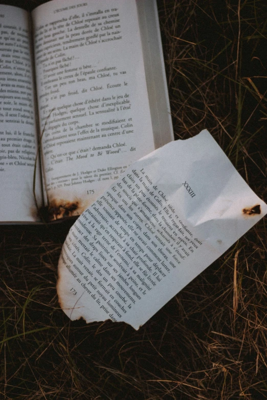 an open book with a piece of paper stuck to the side