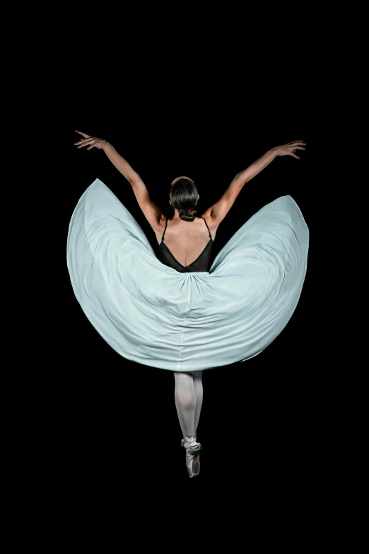 an aerial image of a woman in a light blue gown