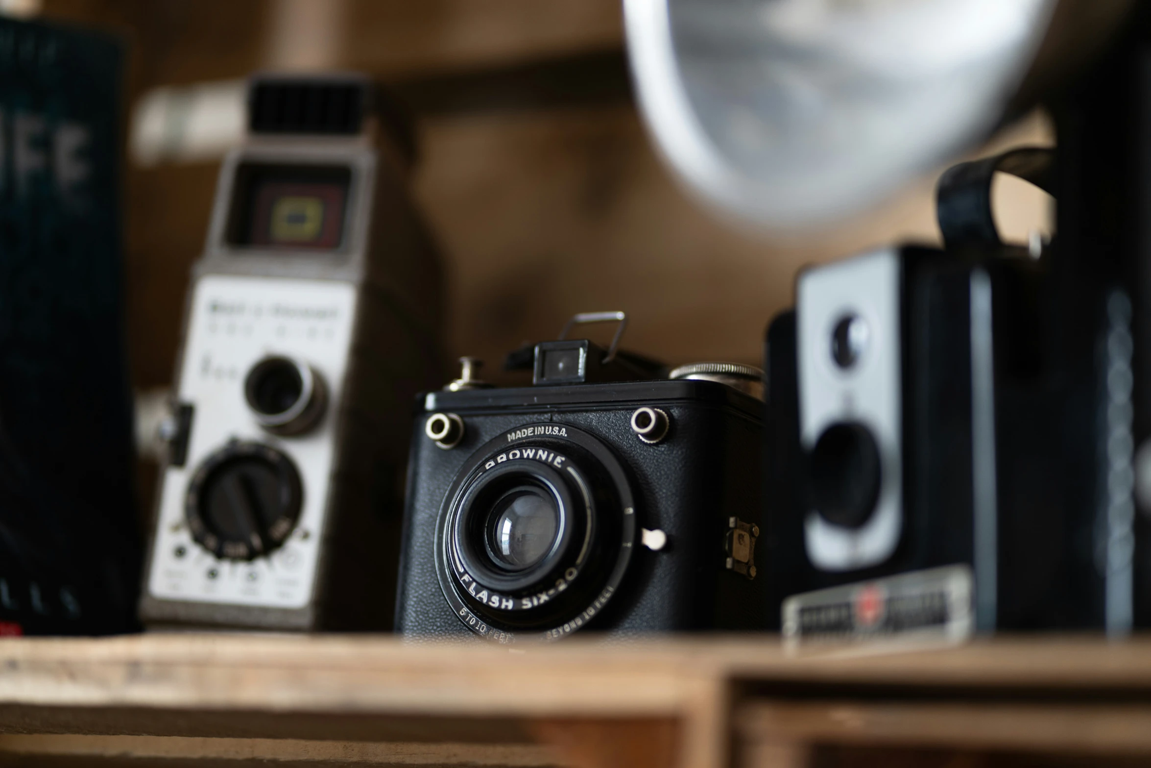 a camera sitting on top of a wooden table next to other objects