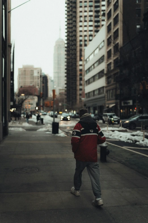 a person walking down a street next to a building